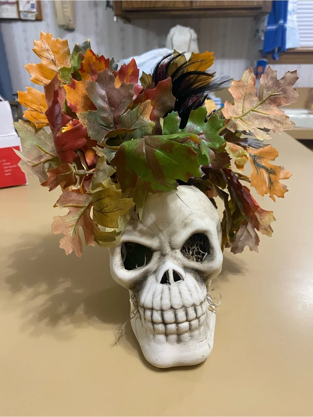 White Skull Vase with Autumn Leaf Faux Floral Arrangement